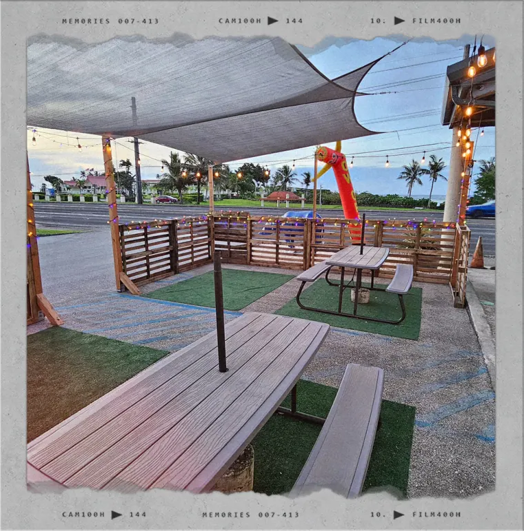 Shaded picnic tables on the Pit Stop taproom patio