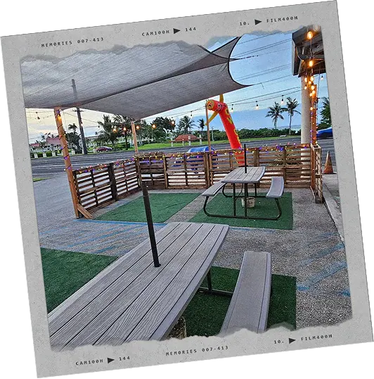 Shaded picnic tables on the taproom patio